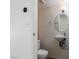 Bright bathroom featuring a modern toilet, sink with silver faucet, and circular mirror at 5523 Orchard Ln # 0, Las Vegas, NV 89110