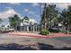 Community entrance gate with mature trees and landscaping, and a brick-paved street at 5523 Orchard Ln # 0, Las Vegas, NV 89110