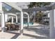 Community pool area featuring a BBQ grill and dining table under a shaded pergola near mature trees at 5523 Orchard Ln # 0, Las Vegas, NV 89110