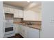 Functional kitchen with mosaic backsplash, laminate counters, and modern appliances for convenient meal preparation at 5523 Orchard Ln # 0, Las Vegas, NV 89110