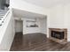 Bright living space featuring laminate floors, a fireplace, and an open layout into the kitchen area at 5523 Orchard Ln # 0, Las Vegas, NV 89110
