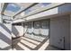Private covered patio with whitewashed walls, concrete flooring, and access via glass doors at 5523 Orchard Ln # 0, Las Vegas, NV 89110