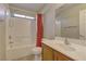 Bathroom featuring a tiled shower, toilet, and single sink at 5552 Dueces Wild Ct # 101, Las Vegas, NV 89122