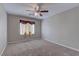 Bedroom with neutral walls, carpet, a ceiling fan, and window with decorative curtain at 5552 Dueces Wild Ct # 101, Las Vegas, NV 89122