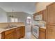 Kitchen with wood cabinets, a breakfast bar, and views of the living area at 5552 Dueces Wild Ct # 101, Las Vegas, NV 89122