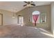 Open living space with large windows, ceiling fan, and seamless flow to other areas at 5552 Dueces Wild Ct # 101, Las Vegas, NV 89122