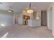 Open-concept living area featuring a ceiling fan and seamless transition to the adjacent kitchen at 5552 Dueces Wild Ct # 101, Las Vegas, NV 89122