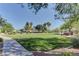 Community park with lush green lawn, mature trees, and walking path at 5552 Dueces Wild Ct # 101, Las Vegas, NV 89122