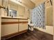 Bathroom featuring wood-look flooring, neutral vanity, and a shower with blue patterned curtain at 5750 E Hacienda Ave # 107, Las Vegas, NV 89122