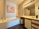 Bathroom with a soaking tub, vanity, and modern lighting at 5750 E Hacienda Ave # 107, Las Vegas, NV 89122