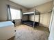Cozy bedroom featuring a functional bunk bed, carpet, and window with natural light at 5750 E Hacienda Ave # 107, Las Vegas, NV 89122