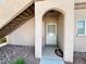 Inviting entrance with an arched entryway, security door, and staircase to upper levels at 5750 E Hacienda Ave # 107, Las Vegas, NV 89122