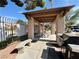 Outdoor picnic and grill area featuring a grill, stone benches, and shaded seating at 5750 E Hacienda Ave # 107, Las Vegas, NV 89122