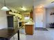 Galley kitchen with stainless steel appliances, cream-colored cabinets, and a view of the living space at 5750 E Hacienda Ave # 107, Las Vegas, NV 89122