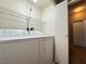 Functional laundry room features a washer, dryer, and wire shelving for storage at 5750 E Hacienda Ave # 107, Las Vegas, NV 89122