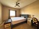 Cozy main bedroom with carpet, a ceiling fan, and a side desk at 5750 E Hacienda Ave # 107, Las Vegas, NV 89122
