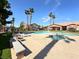 Outdoor pool and spa area with lounge chairs, landscaping, and nearby community buildings at 5750 E Hacienda Ave # 107, Las Vegas, NV 89122
