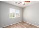 A bedroom with wood-look floors and a window with blinds at 6308 Anticline Ave, Las Vegas, NV 89139