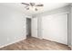 A bedroom has wood-look floors, a ceiling fan, and a closet at 6308 Anticline Ave, Las Vegas, NV 89139