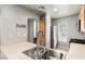 Updated kitchen with stainless steel appliances and a large sink with views to stairs at 6308 Anticline Ave, Las Vegas, NV 89139