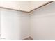 Bright walk-in closet featuring a wood rod and white shelving for optimal storage solutions at 6308 Anticline Ave, Las Vegas, NV 89139