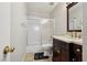 Cozy bathroom featuring a shower-tub combination with sliding glass doors and a dark wood vanity at 6812 Coral Rock Dr, Las Vegas, NV 89108