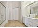 Spacious bathroom featuring a shower-tub combination with glass doors and a vanity at 6812 Coral Rock Dr, Las Vegas, NV 89108