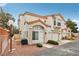 Attractive two-story townhome featuring a red tile roof and stucco exterior, with a one-car garage at 6812 Coral Rock Dr, Las Vegas, NV 89108