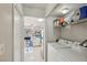 A glimpse from the laundry room showing the kitchen and bright dining area, offering lots of space at 6812 Coral Rock Dr, Las Vegas, NV 89108