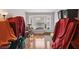 The Living Room has hardwood floors, a bay window and is covered in red sheets at 6812 Coral Rock Dr, Las Vegas, NV 89108