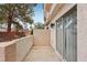 An outdoor patio area with stucco walls and sliding glass doors leading to the interior at 6812 Coral Rock Dr, Las Vegas, NV 89108