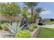 Landscaped backyard with lush greenery and decorative water features, perfect for relaxation at 6845 Hidden Sunset Ln, Las Vegas, NV 89120
