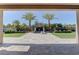 Framed view of the backyard with lush landscaping and decorative water features at 6845 Hidden Sunset Ln, Las Vegas, NV 89120