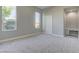 Well-lit bedroom with carpeted floors, a built-in desk, and multiple windows offering views at 6845 Hidden Sunset Ln, Las Vegas, NV 89120