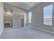 Bright bedroom with carpet, a built-in desk, and windows providing natural light and outdoor views at 6845 Hidden Sunset Ln, Las Vegas, NV 89120