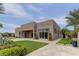 Stunning modern home exterior featuring a well-manicured lawn, and elegant landscaping at 6845 Hidden Sunset Ln, Las Vegas, NV 89120
