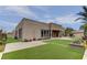 Modern home exterior with a landscaped yard and manicured lawn, creating a welcoming ambiance at 6845 Hidden Sunset Ln, Las Vegas, NV 89120