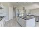 Modern kitchen with white cabinets, stainless steel appliances, and a large kitchen island at 6845 Hidden Sunset Ln, Las Vegas, NV 89120