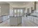 Spacious kitchen featuring marble countertops, a center island, and stainless steel appliances at 6845 Hidden Sunset Ln, Las Vegas, NV 89120