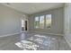 Bright living room with large windows, a door to the backyard, and modern finishes at 6845 Hidden Sunset Ln, Las Vegas, NV 89120