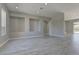 The spacious living room features gray walls, light floors, recessed lighting, and three built in display areas at 6845 Hidden Sunset Ln, Las Vegas, NV 89120