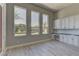 Home office with large windows offering a view of the landscaped backyard and built-in desk at 6845 Hidden Sunset Ln, Las Vegas, NV 89120