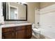 Bathroom featuring a vanity with dark wood cabinets, granite countertop, and a shower-tub combo at 6929 Homing Pigeon Pl, North Las Vegas, NV 89084