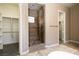 Walk-in shower of primary bathroom with built-in seat and travertine tiling at 6929 Homing Pigeon Pl, North Las Vegas, NV 89084