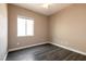 Cozy bedroom featuring a window, ceiling fan, and wood-look floors, providing a comfortable living space at 6929 Homing Pigeon Pl, North Las Vegas, NV 89084