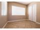 Bright bedroom with tiled floor, closet and natural light from the large window at 6929 Homing Pigeon Pl, North Las Vegas, NV 89084