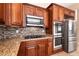 Close-up on kitchen with stainless steel appliances, granite countertops, and tile backsplash at 6929 Homing Pigeon Pl, North Las Vegas, NV 89084