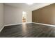Contemporary living room with wood floors and neutral tones that leads into the bathroom at 6929 Homing Pigeon Pl, North Las Vegas, NV 89084