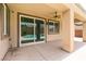 Covered patio, ceiling fan, and sliding glass doors to the backyard pool area at 6929 Homing Pigeon Pl, North Las Vegas, NV 89084