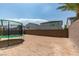 View of the backyard with a trampoline and brick wall, offering a secure and private space at 7077 Sunland Hills Ave, Las Vegas, NV 89113